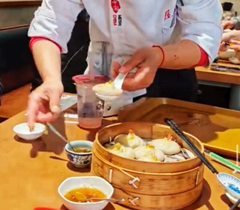 How to Eat Xiao Long Bao Demo by Friendly Staff