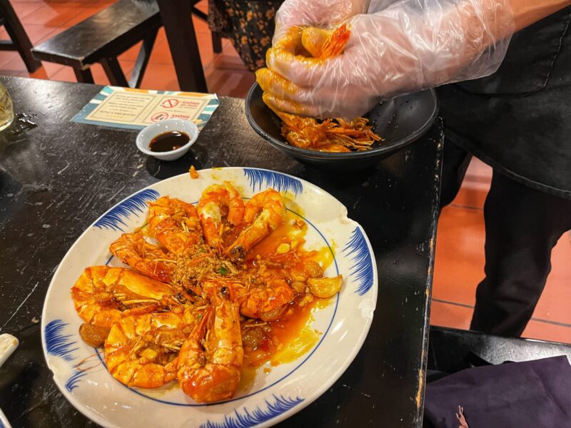 Moc Quan Staff help peel the seafood shells