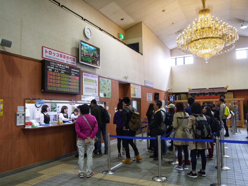 People queuing at Kameoka Torokko station before boarding